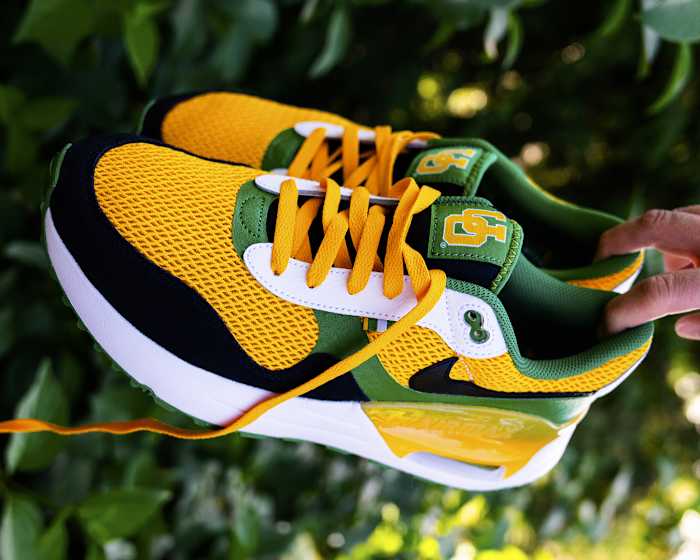 Side view of green, yellow, and black Nike sneakers.